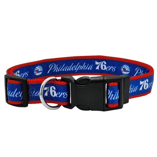 Philadelphia 76ers dog collar with a blue and red woven strap, featuring the team logo and name in white, complete with a black plastic buckle and a silver metal ring.